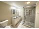 Modern bathroom featuring dual vanities, granite countertops, glass shower, and stylish tile at 6069 Wisteria Ln, Lithia Springs, GA 30122