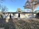 Back exterior of single-story home with patio, grassy yard, and mature trees at 6069 Wisteria Ln, Lithia Springs, GA 30122