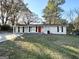 Charming exterior with a red door and lush landscaping at 6069 Wisteria Ln, Lithia Springs, GA 30122
