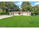 Single-story home with a large front lawn and trees at 6069 Wisteria Ln, Lithia Springs, GA 30122