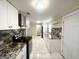 Bright kitchen with granite countertops, white cabinets, and modern appliances at 6069 Wisteria Ln, Lithia Springs, GA 30122