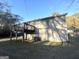 Private backyard with a deck, storage space, and mature trees at 2843 Marco Nw Dr, Atlanta, GA 30318