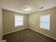 Spacious bedroom with neutral walls, carpeted flooring, and two large windows at 2843 Marco Nw Dr, Atlanta, GA 30318