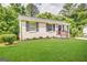 Charming single-story home with a lush green lawn and mature trees at 2843 Marco Nw Dr, Atlanta, GA 30318