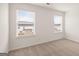 Bedroom featuring neutral-colored carpet and two large windows at 671 Edgar St, Hampton, GA 30228