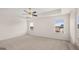 Spacious bedroom with plush carpet, ceiling fan, and large windows at 671 Edgar St, Hampton, GA 30228