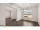 Dining room with wood-look floors, coffered ceiling, and a chandelier at 671 Edgar St, Hampton, GA 30228