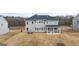 Backyard view of a two-story house with a covered patio and large yard at 671 Edgar St, Hampton, GA 30228
