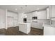 Spacious kitchen with white cabinetry, stainless steel appliances, a center island, and wood flooring at 671 Edgar St, Hampton, GA 30228