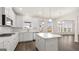 Open kitchen with an island, white cabinets, stainless steel appliances, and a breakfast nook at 671 Edgar St, Hampton, GA 30228