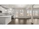 Bright, open kitchen with white cabinets, stainless steel appliances, and large windows at 671 Edgar St, Hampton, GA 30228