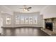 Living room with dark wood floors, a fireplace, and bay windows at 671 Edgar St, Hampton, GA 30228