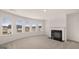 Large living room with bay windows, fireplace, and plush carpet at 671 Edgar St, Hampton, GA 30228