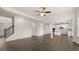 Open living room and kitchen with hardwood floors, ceiling fan, and natural light at 671 Edgar St, Hampton, GA 30228