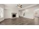 Living room with a fireplace, ceiling fan, and hardwood floors at 671 Edgar St, Hampton, GA 30228