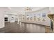 Open-concept living room and kitchen with dark wood floors, fireplace, and lots of natural light at 671 Edgar St, Hampton, GA 30228