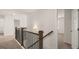 Upstairs hallway with carpeted floors and wood railing at 671 Edgar St, Hampton, GA 30228