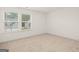 Bright, empty bedroom with large windows and neutral carpeting at 1715 Goodwin Dr # 30, Hampton, GA 30228