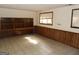 Basement room with wood paneling, built-in shelves, and tiled floor at 3761 N Camp Creek Sw Pkwy, Atlanta, GA 30331