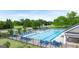 Community swimming pool with a splash pad, lounge chairs, and adjacent pool house at 663 Edgar St # 25, Hanpton, GA 30228