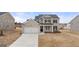 New construction home with brick and siding exterior, front-facing two-car garage, and landscaping at 663 Edgar St # 25, Hampton, GA 30228