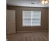 Simple bedroom with carpet, blinds, and neutral walls at 5330 Creekview Ln, Morrow, GA 30260