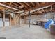 Partially finished basement with laundry area, exposed framing, and concrete floors at 3727 Calmer Cir, East Point, GA 30344