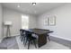 Dining room with modern table, black chairs, and large window at 1025 Claas Way, Locust Grove, GA 30253