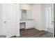 Bathroom with single vanity, granite countertop, white cabinets, and wood-look flooring at 1024 Claas Way, Locust Grove, GA 30253