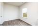 Empty bedroom with wood-look flooring and natural light at 1024 Claas Way, Locust Grove, GA 30253