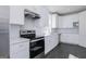 Modern kitchen with white cabinets, stainless steel appliances, and sleek countertops at 1024 Claas Way, Locust Grove, GA 30253