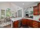 Kitchen with white counters, wood cabinets, and view of dining and living areas at 436 Winged Foot Dr, Mcdonough, GA 30253