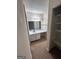 Bathroom featuring a vanity with white countertop, mirror, and storage shelves at 2033 Oak Park Ln, Decatur, GA 30032