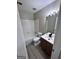 Clean bathroom with white tile, updated vanity, and modern fixtures at 2033 Oak Park Ln, Decatur, GA 30032