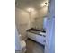 Bathroom with dark countertop, white cabinets, and modern fixtures at 2033 Oak Park Ln, Decatur, GA 30032