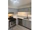 Modern kitchen featuring stainless steel appliances, gray cabinets, and white countertops at 2033 Oak Park Ln, Decatur, GA 30032