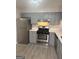 Updated kitchen with stainless steel appliances and gray cabinets at 2033 Oak Park Ln, Decatur, GA 30032