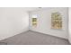 Simple bedroom with neutral carpeting and two large windows at 1723 Goodwin, Hampton, GA 30228