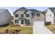 Charming two-story home with a brick and shingle exterior, front yard landscaping, and attached two-car garage at 1723 Goodwin, Hampton, GA 30228
