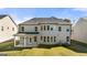 Two-story home with gray siding, covered patio, and landscaped yard at 1723 Goodwin, Hampton, GA 30228