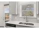 Modern kitchen with gray cabinets, stainless steel appliances, and a view at 1723 Goodwin, Hampton, GA 30228
