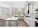 Modern kitchen with gray cabinets, island, and stainless steel appliances at 1723 Goodwin, Hampton, GA 30228