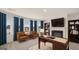 Home office with fireplace, built-in shelving, and large windows at 1723 Goodwin, Hampton, GA 30228