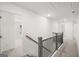 Upstairs hall with neutral carpeting and a modern railing at 1723 Goodwin, Hampton, GA 30228
