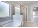 Clean bathroom with shower, tub, and window at 655 Edgar St, Hampton, GA 30228