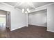 Formal dining room with hardwood floors and elegant chandelier at 655 Edgar St, Hampton, GA 30228