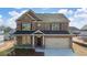 New construction home with a two-car garage and a covered front porch at 655 Edgar St, Hampton, GA 30228
