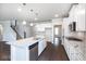 Modern kitchen with white cabinets, granite countertops, and stainless steel appliances at 655 Edgar St, Hampton, GA 30228