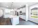 Modern kitchen with white cabinets, granite countertops, and stainless steel appliances at 655 Edgar St, Hampton, GA 30228