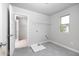Bright laundry room with washer and dryer hookups, built-in shelving, and tile flooring at 655 Edgar St, Hampton, GA 30228